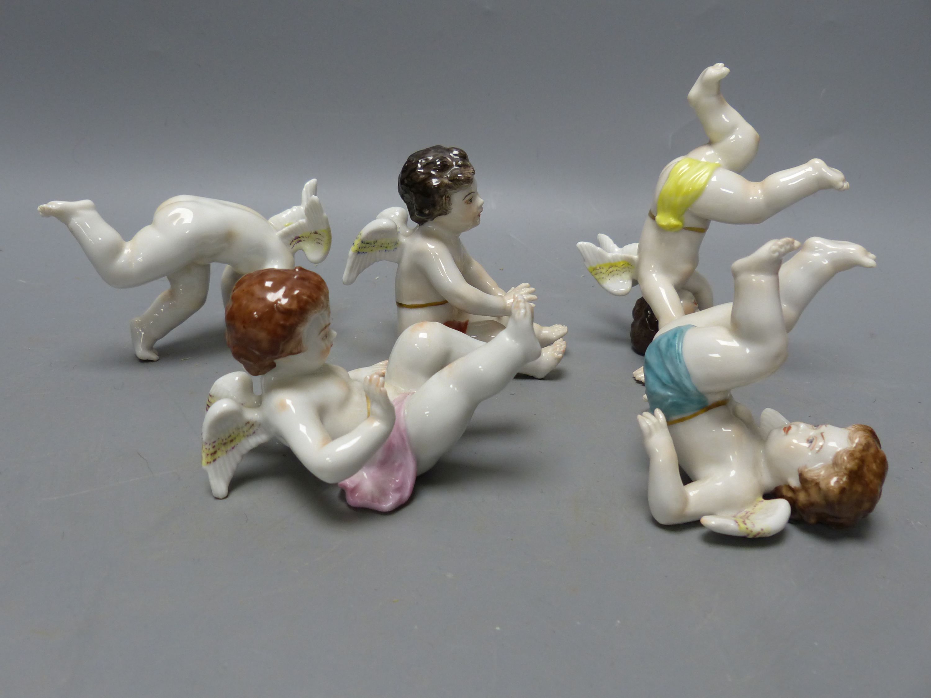 Five Continental porcelain cherubs, tallest 8cm